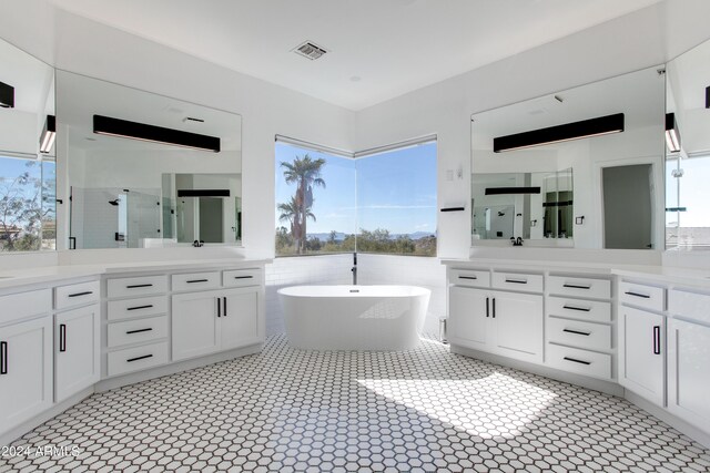 bathroom with vanity, tile walls, and a bath