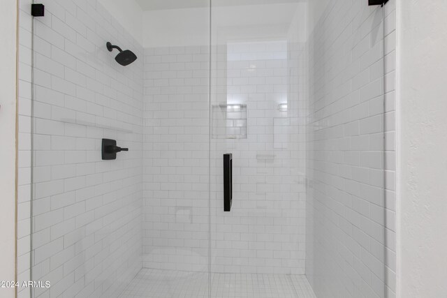 bedroom with ensuite bath and light wood-type flooring