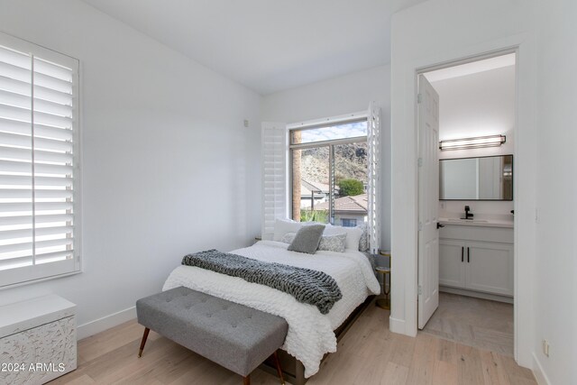 bedroom featuring multiple windows and a mountain view