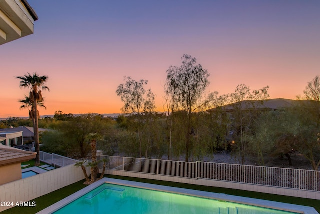 view of pool at dusk