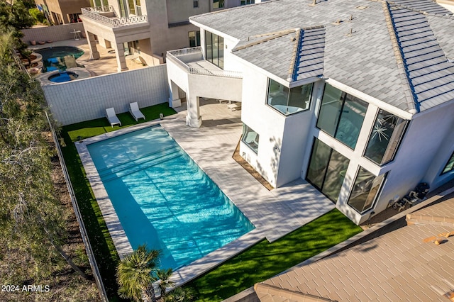 view of pool featuring a hot tub and a patio area