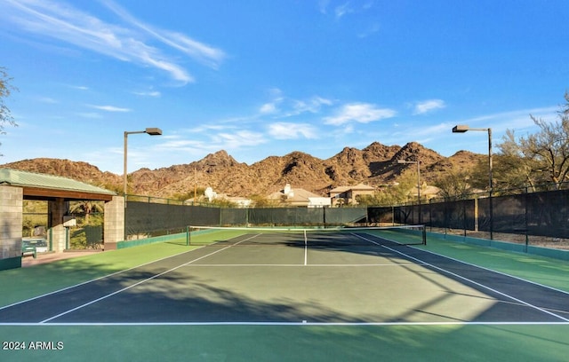 view of tennis court with a mountain view