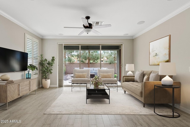 living area featuring baseboards, a ceiling fan, wood finished floors, and crown molding