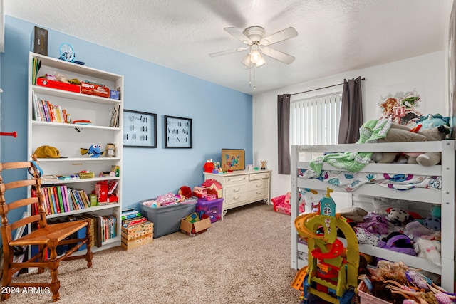 carpeted bedroom with ceiling fan and a textured ceiling