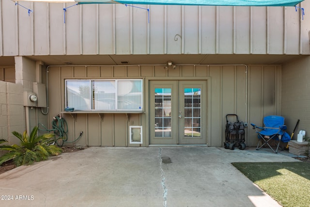 view of exterior entry featuring french doors and a patio