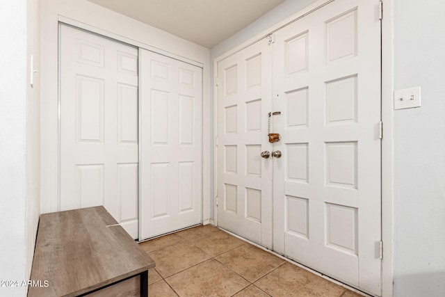 entryway with light tile patterned flooring