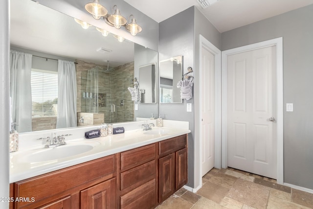 bathroom with vanity and a shower with door