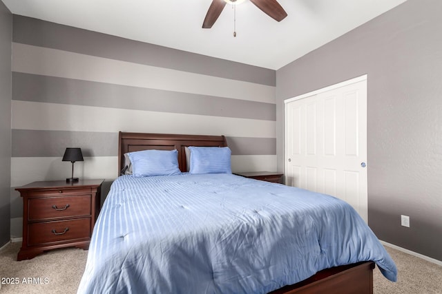 carpeted bedroom with ceiling fan and a closet