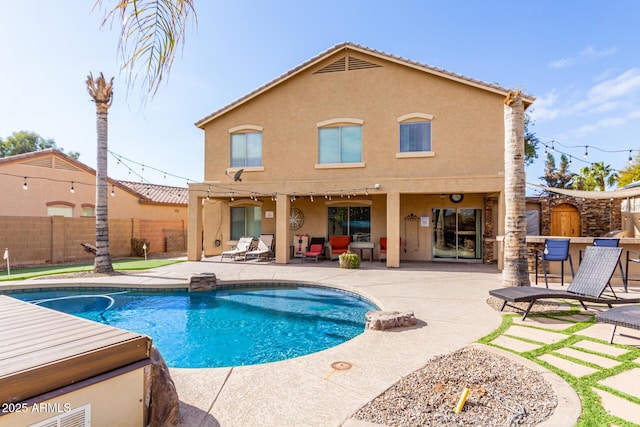 back of house featuring a fenced in pool and a patio area