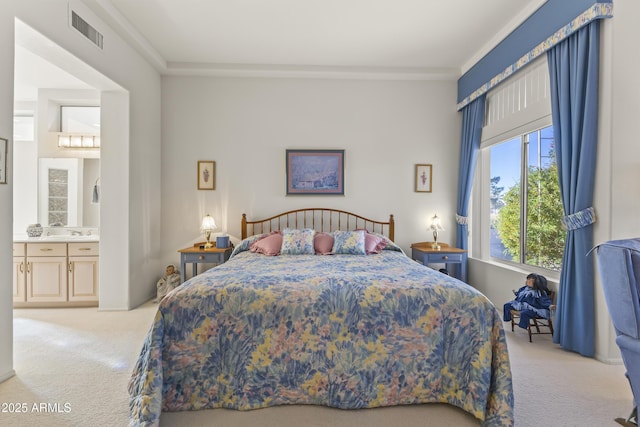 bedroom featuring connected bathroom, light carpet, a sink, visible vents, and ornamental molding