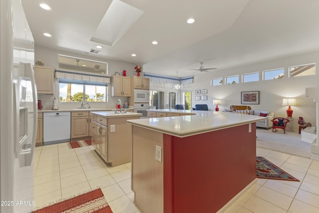 kitchen featuring a large island, light tile patterned floors, light countertops, open floor plan, and white appliances