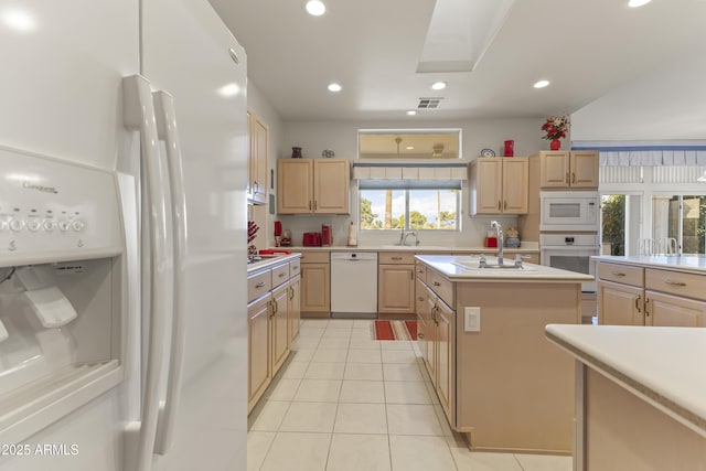 kitchen featuring light countertops, visible vents, light brown cabinetry, light tile patterned flooring, and white appliances