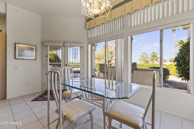 dining room with light tile patterned floors, french doors, and a notable chandelier