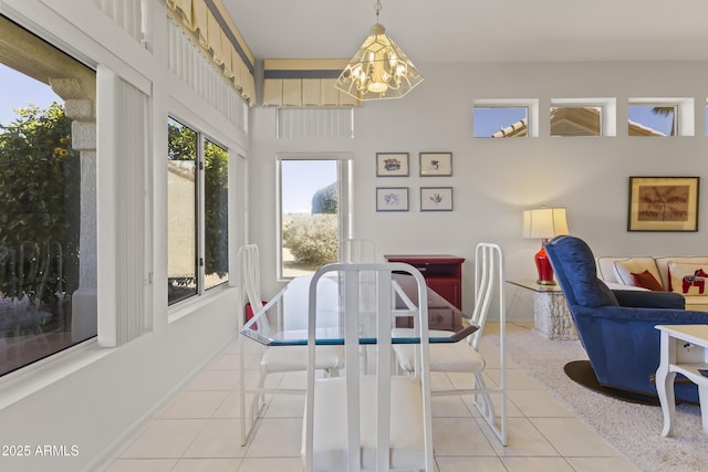 dining space with light tile patterned floors, baseboards, and a notable chandelier