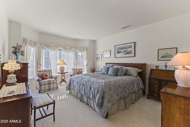 bedroom featuring light carpet and visible vents