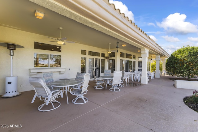 view of patio with french doors, outdoor dining space, and a ceiling fan