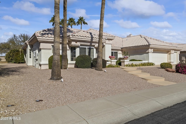 view of front of house featuring a tile roof and stucco siding