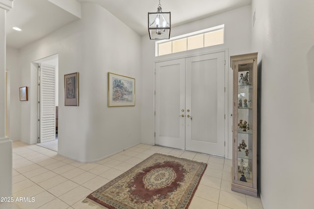 entryway with recessed lighting, a notable chandelier, and light tile patterned floors