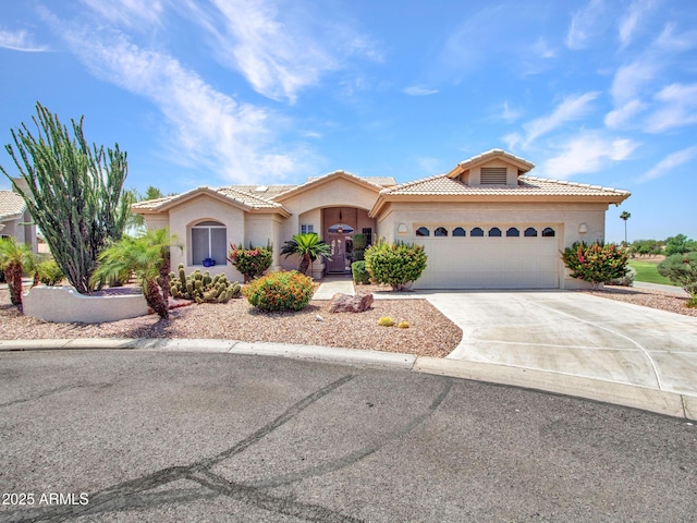 15377 W Catalina Ct, Goodyear, AZ 85395 - mediterranean / spanish-style home with a tile roof, concrete driveway, a garage, and stucco siding