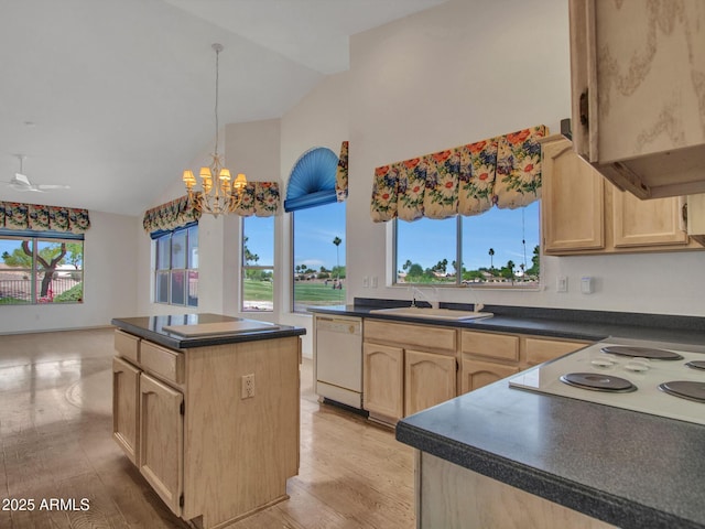 15377 W Catalina Ct, Goodyear, AZ 85395 - kitchen featuring white appliances, light brown cabinetry, vaulted ceiling, dark countertops, and light wood finished floors