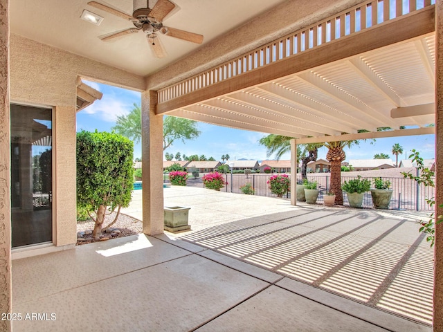 15377 W Catalina Ct, Goodyear, AZ 85395 - fenced backyard with a patio area, a pergola, a ceiling fan, and a residential view