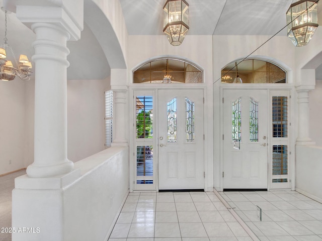 15377 W Catalina Ct, Goodyear, AZ 85395 - foyer featuring plenty of natural light, a chandelier, light tile patterned floors, and arched walkways