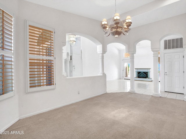 15377 W Catalina Ct, Goodyear, AZ 85395 - unfurnished living room featuring a chandelier, carpet floors, tile patterned flooring, and a fireplace with raised hearth
