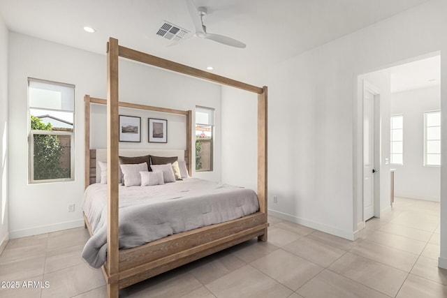 tiled bedroom featuring ceiling fan