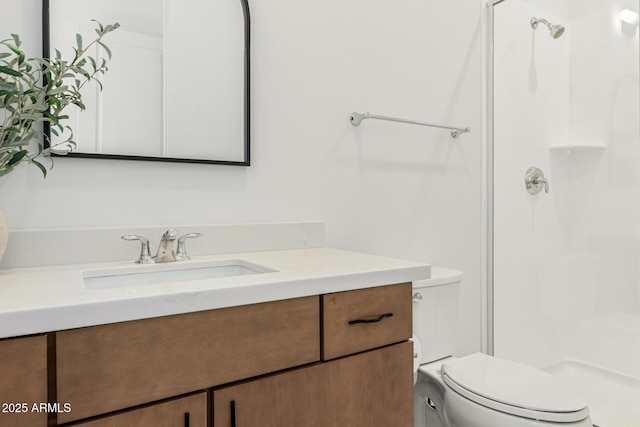 bathroom with a shower, vanity, and toilet