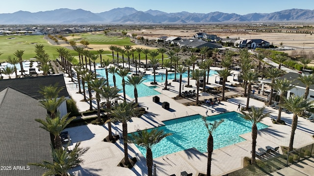 view of swimming pool with a mountain view and a patio