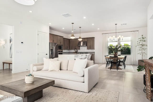 tiled living room with a chandelier