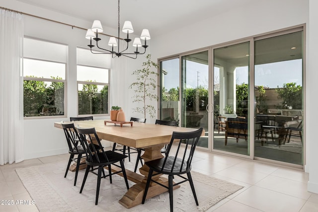 dining room featuring light tile patterned flooring, plenty of natural light, and an inviting chandelier