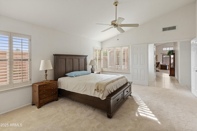 bedroom with ceiling fan, lofted ceiling, and light carpet