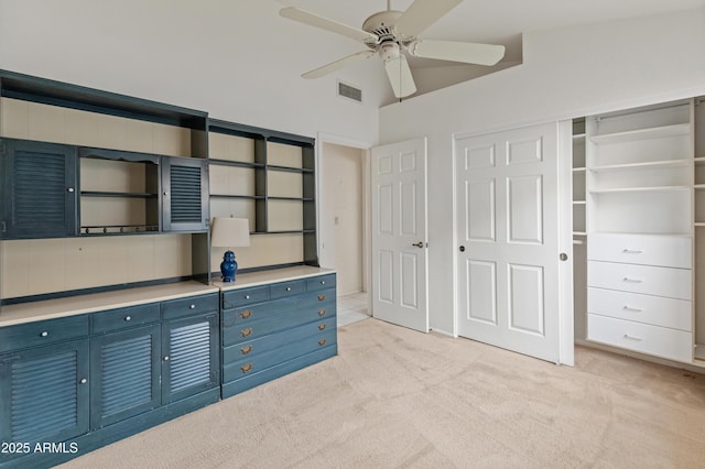 kitchen featuring light carpet, ceiling fan, vaulted ceiling, and blue cabinets