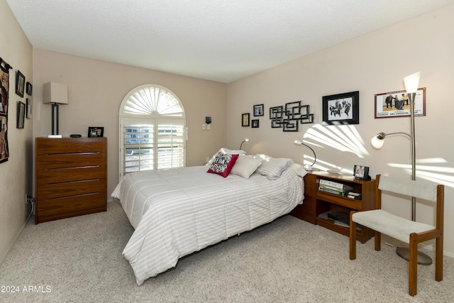 carpeted bedroom featuring a textured ceiling