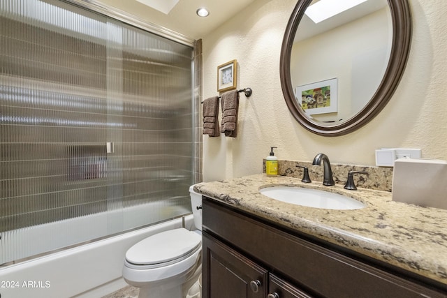 full bathroom with vanity, toilet, and enclosed tub / shower combo