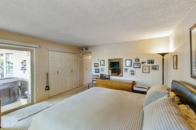 bedroom featuring access to exterior and a textured ceiling