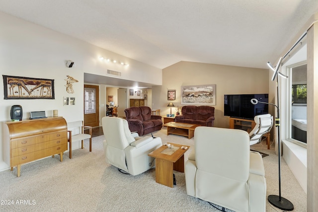 carpeted living room with vaulted ceiling