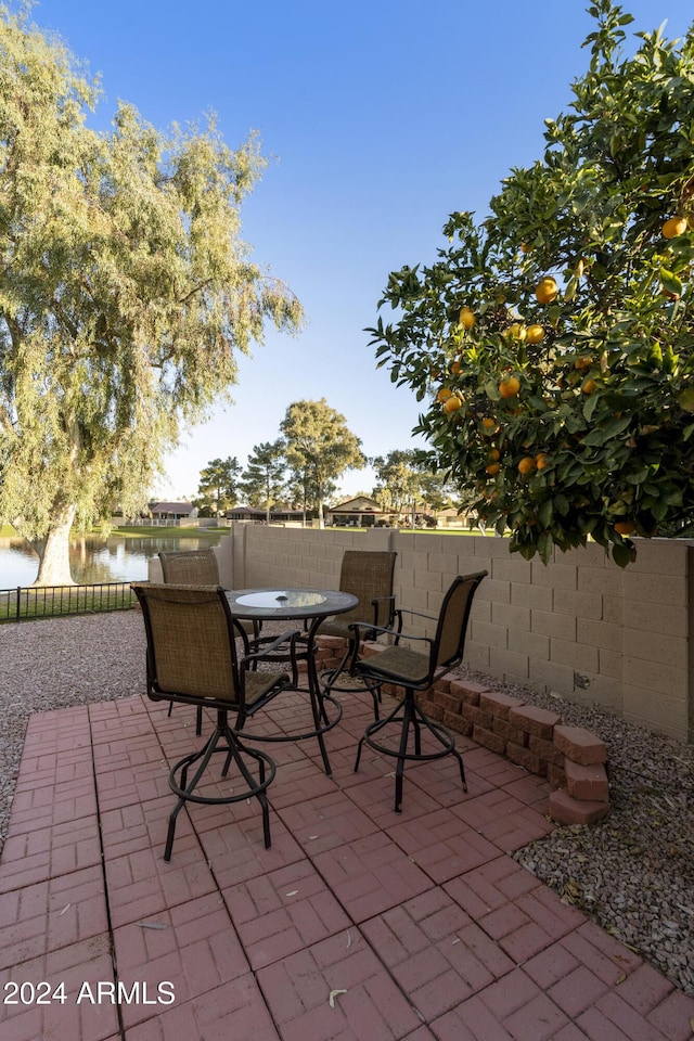 view of patio with a water view