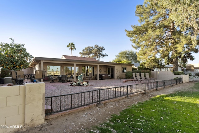 rear view of property featuring a patio area