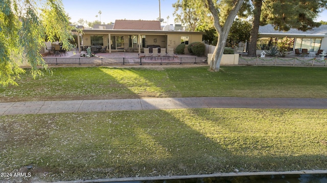 view of front facade with a front yard and a patio area