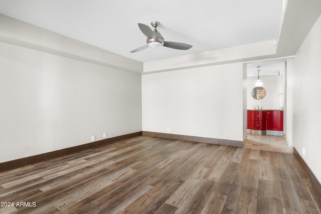 unfurnished living room featuring wood-type flooring and ceiling fan