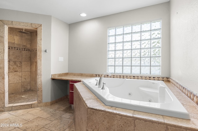 bathroom featuring tile patterned flooring and separate shower and tub