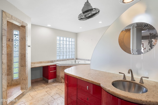 bathroom with vanity, tile patterned flooring, and a bathtub