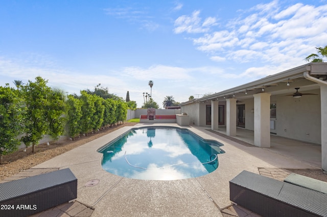 view of pool with ceiling fan and a patio area