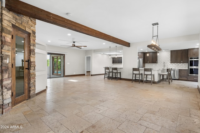 unfurnished living room with light tile patterned flooring, ceiling fan, beamed ceiling, sink, and french doors