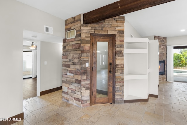 interior space with light wood-type flooring and beam ceiling