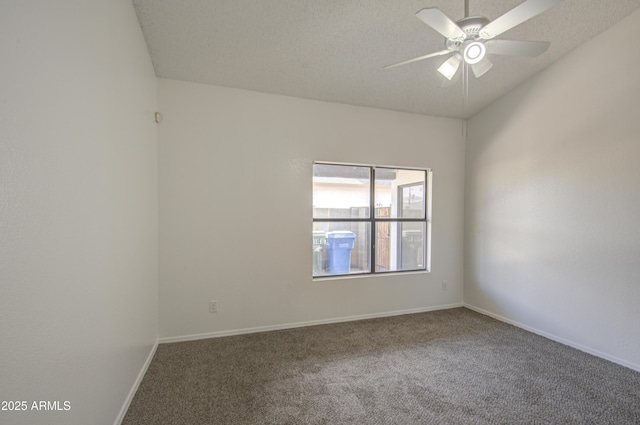 carpeted empty room with ceiling fan and a textured ceiling