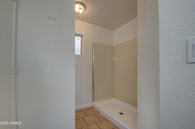 bathroom featuring a shower and tile patterned floors