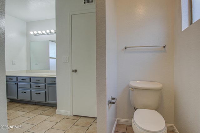 bathroom with vanity, tile patterned floors, and toilet